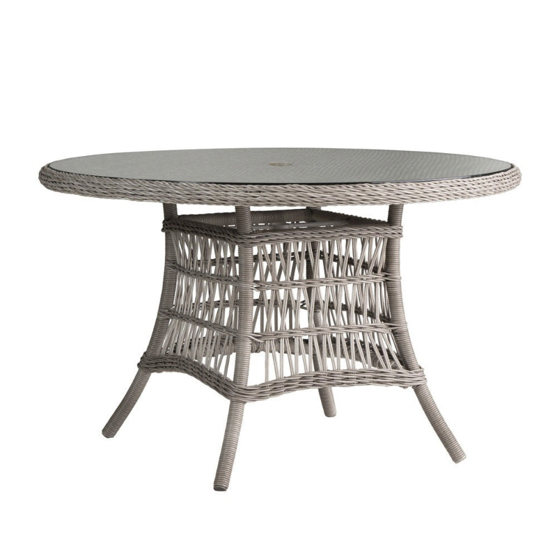 Round wicker table with a glass top on a white background
