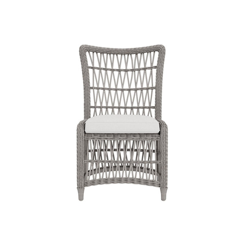 Wicker chair with a white cushion on a white background