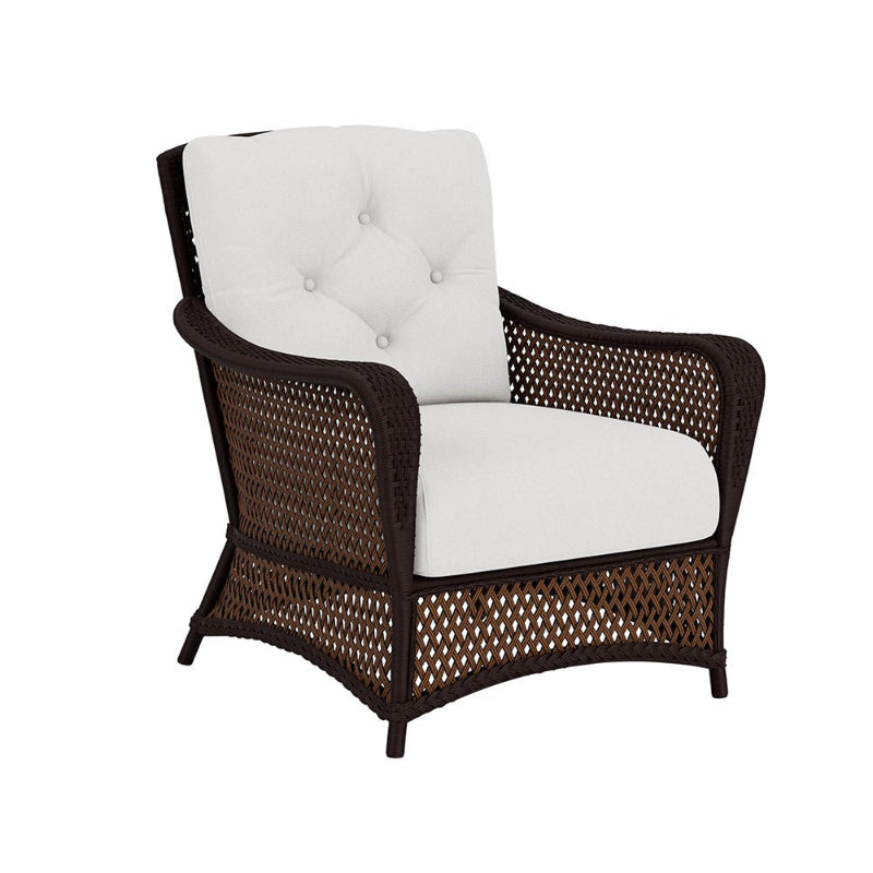 Chair with wicker frame and white cushion on a white background