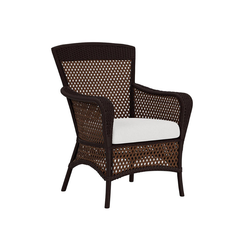Wicker armchair with a white cushion on a white background