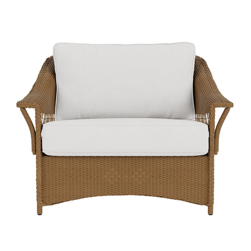 Wicker chair with white cushions on a white background