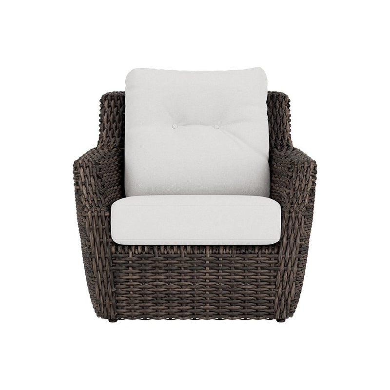 Wicker armchair with white cushions on a white background