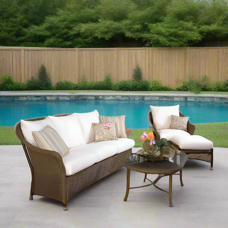 Outdoor patio furniture set with cushions on a wooden deck.