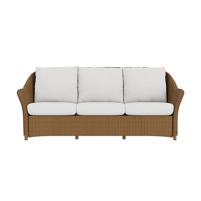 Wicker outdoor sofa with white cushions on a white background