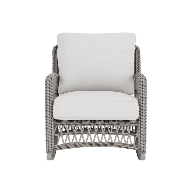 Wicker armchair with white cushions on a white background