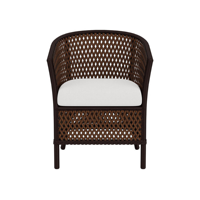 Wicker chair with a white cushion on a white background