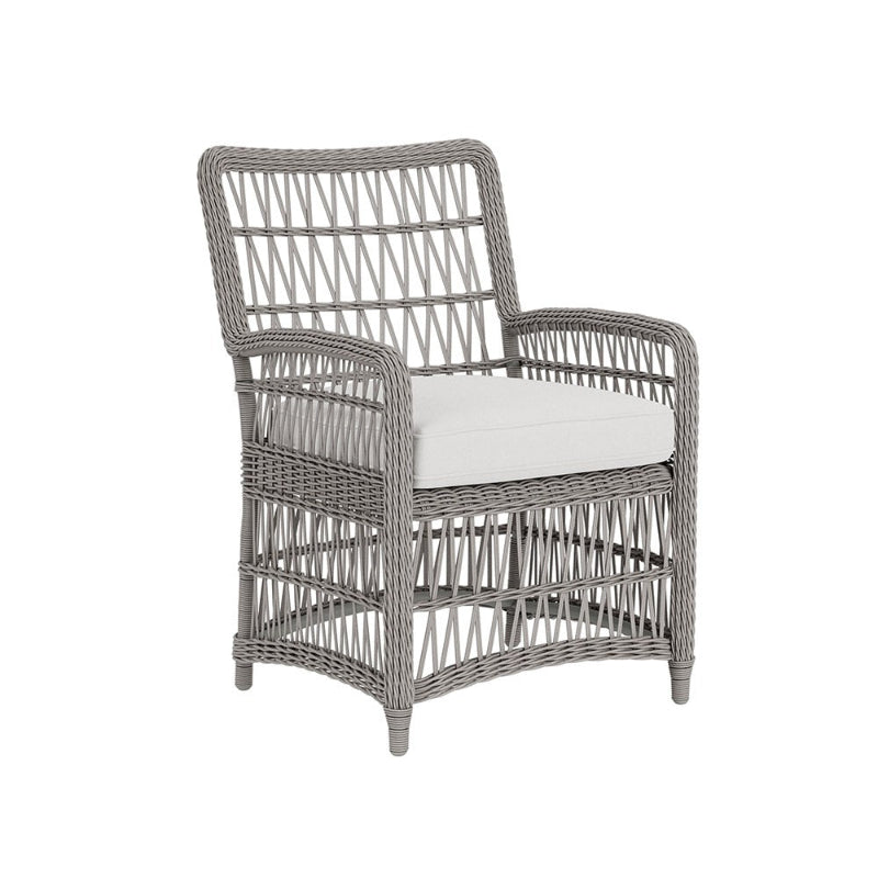 Wicker armchair with a white cushion on a white background