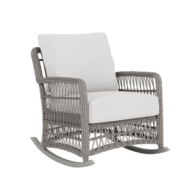 Wicker rocking chair with white cushion on a white background