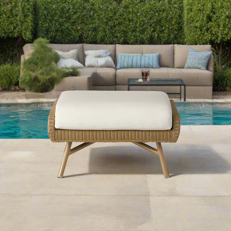 Outdoor patio set with sectional sofa and ottoman by a pool
