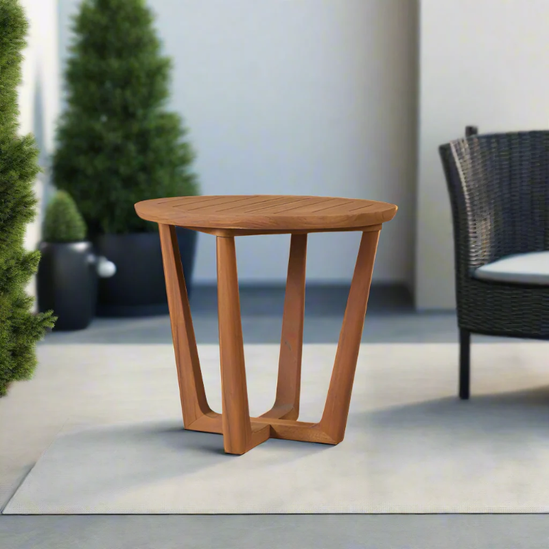 Wooden side table on a patio with outdoor furniture and plants in the background