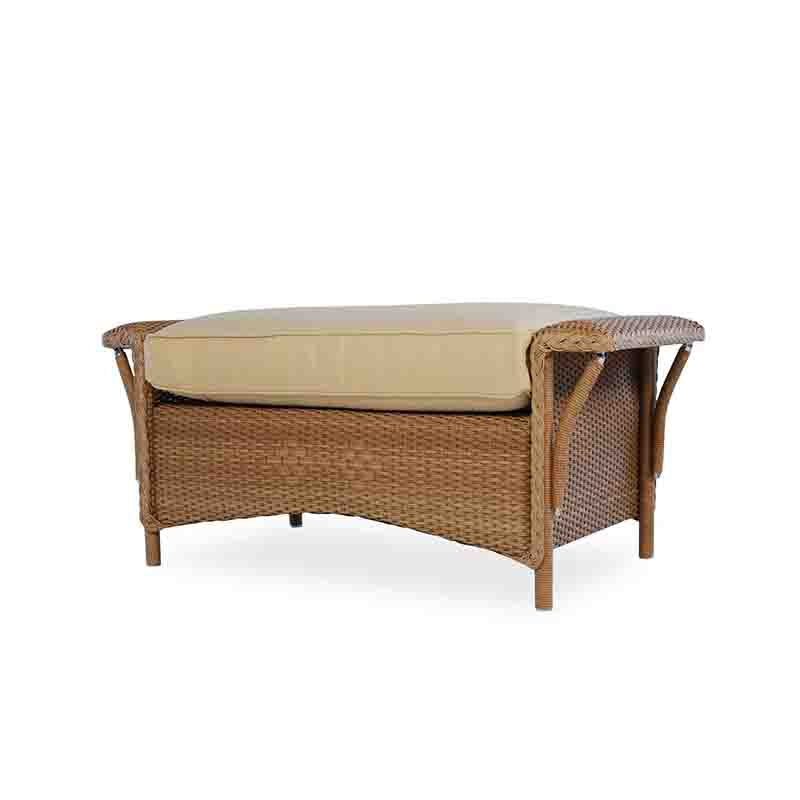 Wicker outdoor bench with beige cushion on a white background