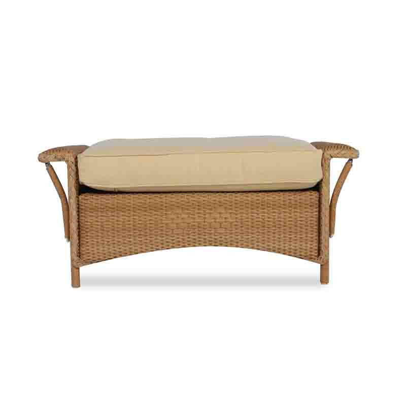 Wicker bench with beige cushion on a white background