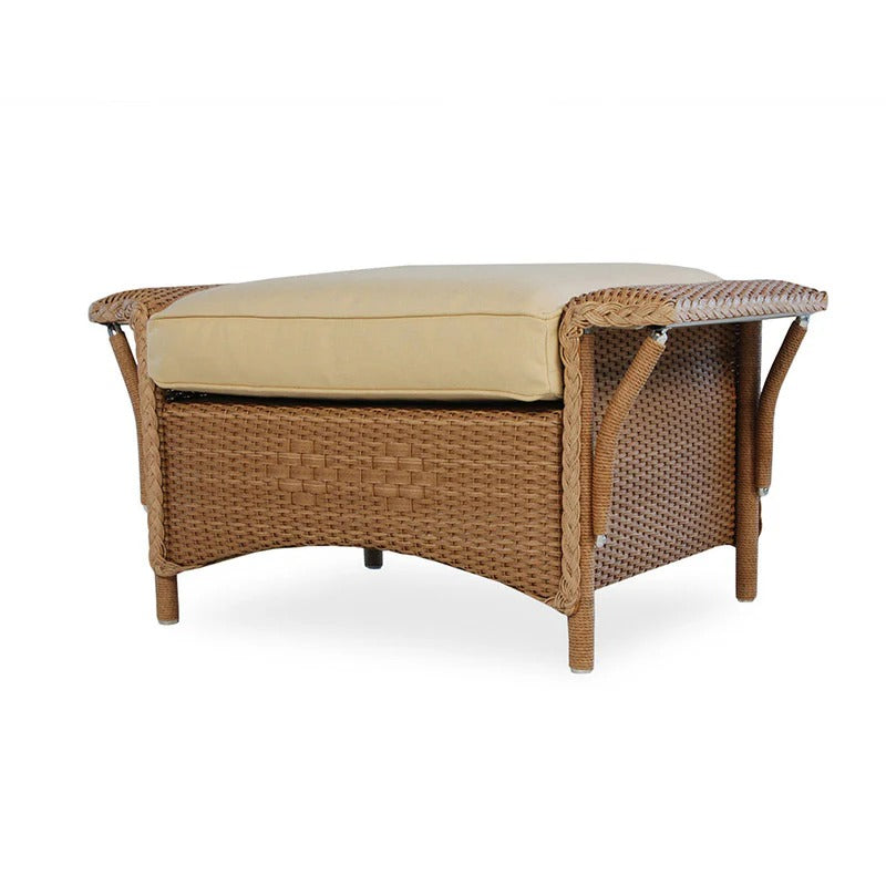 Wicker ottoman with beige cushion on a white background