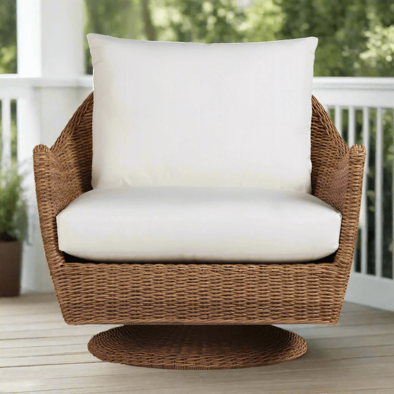 Wicker chair with white cushion on a wooden deck