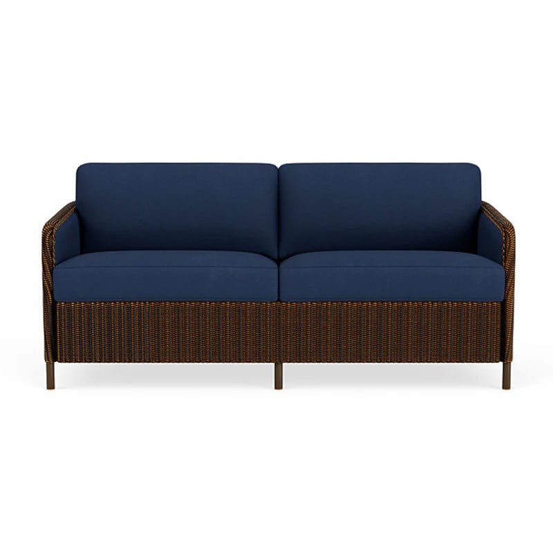 Blue cushioned sofa with brown wicker frame on a white background