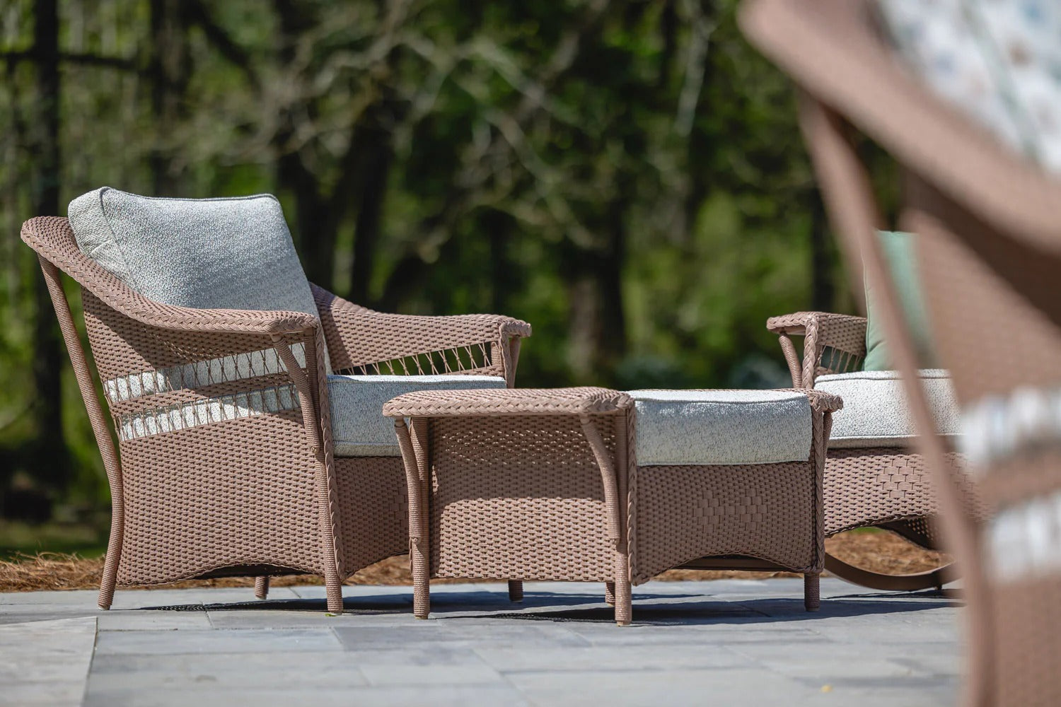 Outdoor furniture set with wicker chairs and table on a patio
