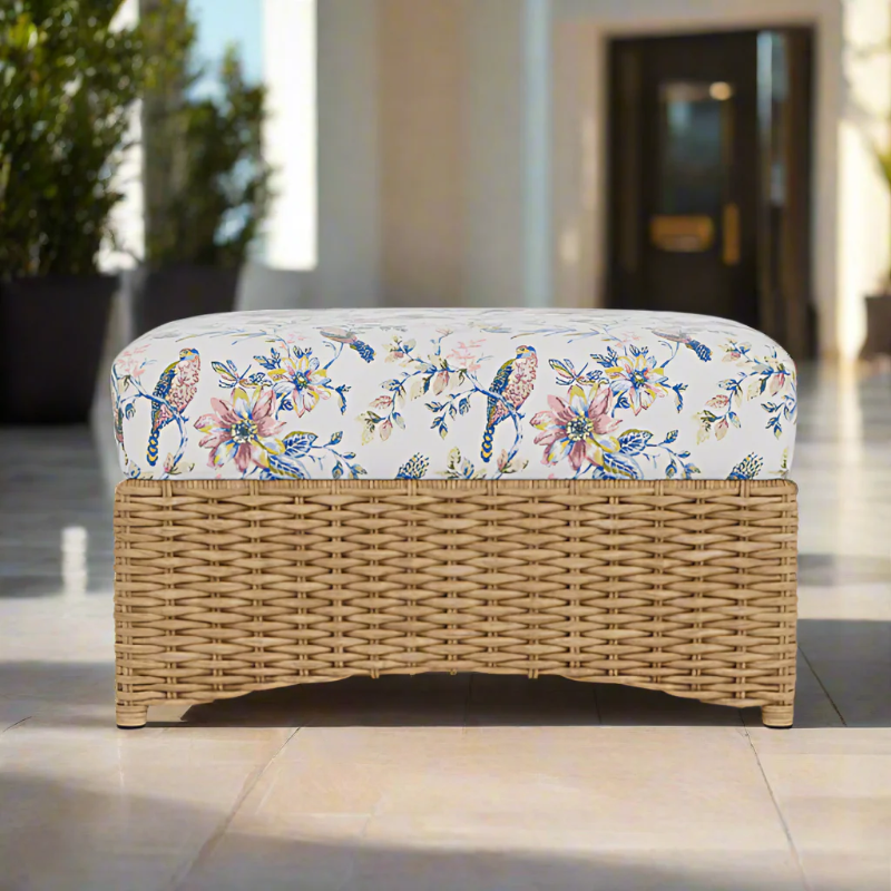 Wicker bench with floral cushion on a patio