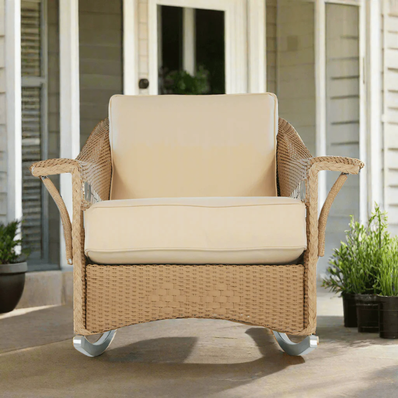 Wicker chair with beige cushions on a patio