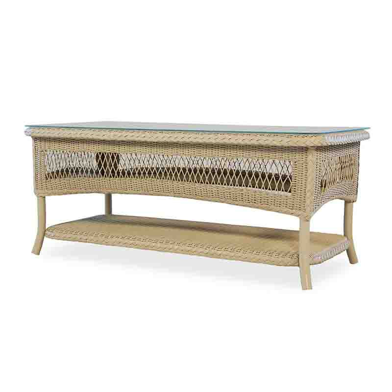 Wicker coffee table with glass top on a white background