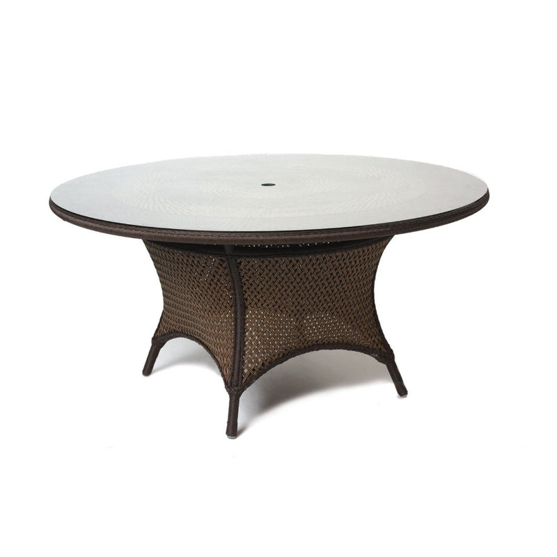 A round Lloyd Flanders wicker dining table with a glass top and umbrella opening, featuring a brown synthetic woven pattern.
